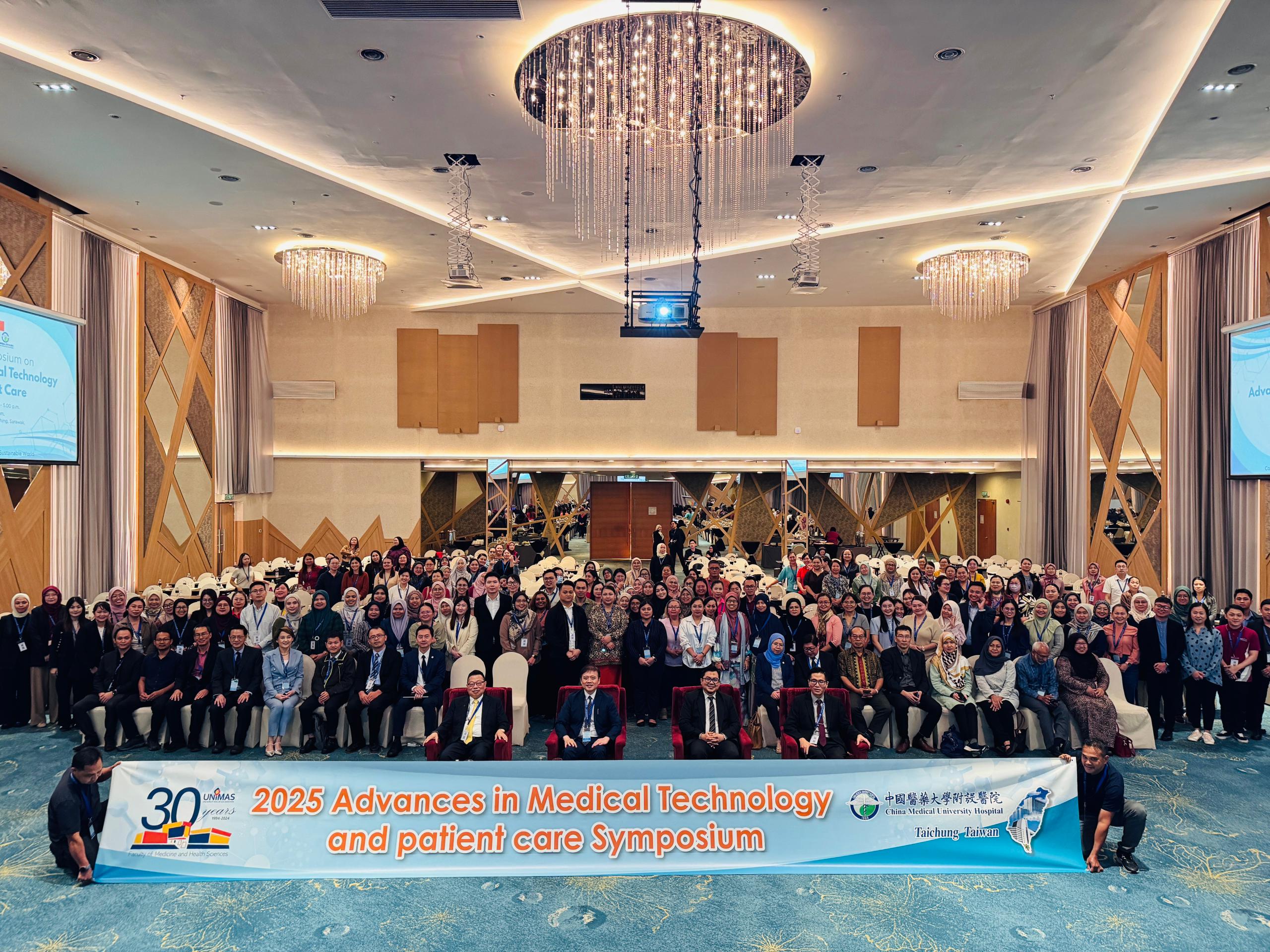 Guests, speakers, and participants at the Advances in Medical Technology and Patient Care Symposium 2025 in Kuching pose for a group photo.